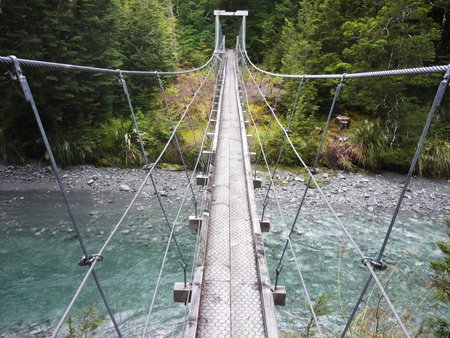 Rope bridge over mountain creek on Rees-Dart trek, New Zealandの写真素材