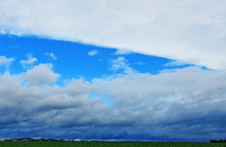 Clouds above a green fieldの写真素材