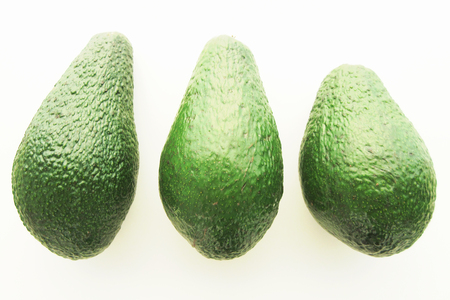 Three avocados isolated on white