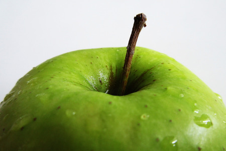 Dew drops on green appleの写真素材