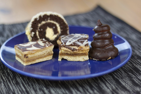 dessert with coffee chocolate cakes and rolls on the table blurred backgroundの写真素材