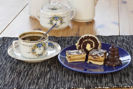 dessert with coffee chocolate cakes and rolls on the table blurred backgroundの写真素材