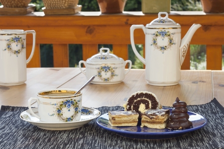 dessert with coffee chocolate cakes and rolls on the table blurred backgroundの写真素材