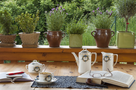 cup of coffee on the terrace relax with a book a time for pipeの写真素材