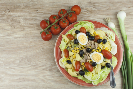 Refreshing summer pasta dish with tuna vegetables olives and egg. Healthy food for athletes.の写真素材
