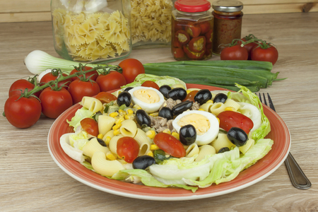 Refreshing summer pasta dish with tuna vegetables olives and egg. Healthy food for athletes.の写真素材