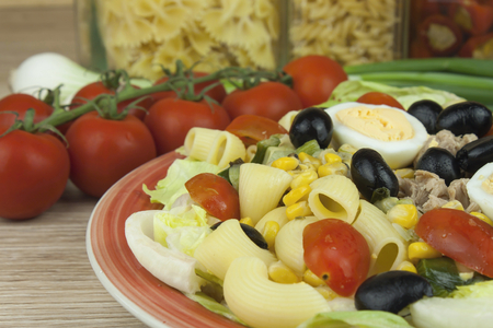 Refreshing summer pasta dish with tuna vegetables olives and egg. Healthy food for athletes.の写真素材