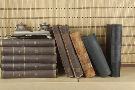 Front view of old books stacked on a shelf. Books without title and author.の写真素材