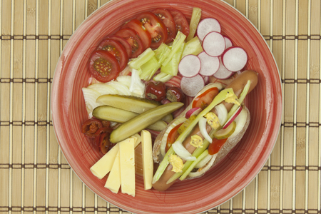 Domestic hotdog with vegetables fast food preparation at home.の写真素材