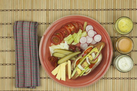 Domestic hotdog with vegetables fast food preparation at home.の写真素材