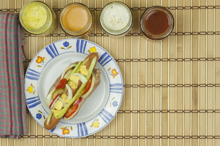 Domestic hotdog with vegetables fast food preparation at home.の写真素材