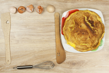 Scrambled egg omelet on a wooden table. A plate of food.の写真素材