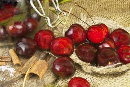 Domestic production of cherry jam. Freshly picked cherries ready for canning. The supply of fruits for the winter and a rainy day. The preparation of sweets for the family.の写真素材