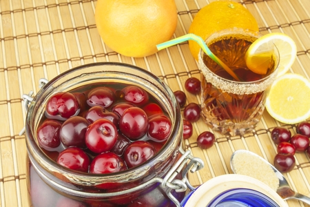 Glasses with cherries with rum. Preparing for summer refreshment cocktail. Cane rum and sugar. Sour pickled in rum.の写真素材