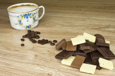 We love coffee and chocolate. Chocolate and coffee on a wooden table. Sweet treat with coffee.の写真素材