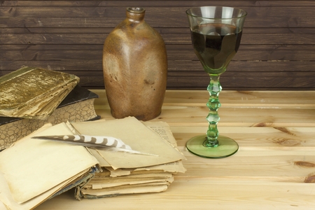 Old books to read. Studying old dictionaries. Historical Library, reading by candlelight. Glasses of red wineの写真素材