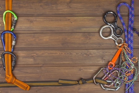 Used climbing gear on wooden background. Advertising boards of trade. The concept of extreme sports. Decoration of older equipment climbers.の写真素材