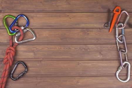 Used climbing gear on wooden background. Advertising boards of trade. The concept of extreme sports. Decoration of older equipment climbers.の写真素材
