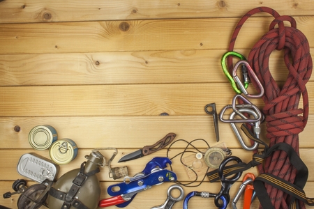 Used climbing gear on wooden background. Advertising boards of trade. The concept of extreme sports....