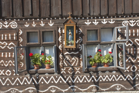 Old wooden window. Unique decoration of log houses based on patterns used in traditional embroidery in village of Cicmany, UNESCO World Heritage Site, Slovakiaのeditorial素材