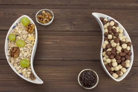 Healthy Diet breakfast of oatmeal, cereal and fruit. Foods full of energy for athletes. The concept of diet food. Preparing homemade breakfast. Vegetarian diet. Food on a wooden table.の写真素材