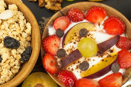 Healthy breakfast with cereals and colorful fruits. Yogurt with fruit and oatmeal. Meals for successful athletes. Food for kids.の写真素材