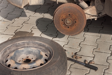 Changing tires or wheel before winter or spring. Preparing the car for the winter. Repair cracked tires.の写真素材