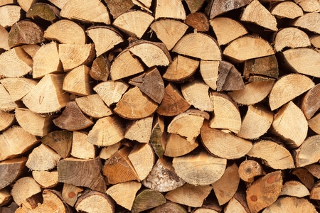 wall firewood , Background of dry chopped firewood logs in a pileの写真素材