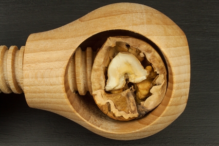 Walnuts and wooden nutcracker. Super foods for human brain. Healthy walnuts. Fresh walnuts. Walnut...