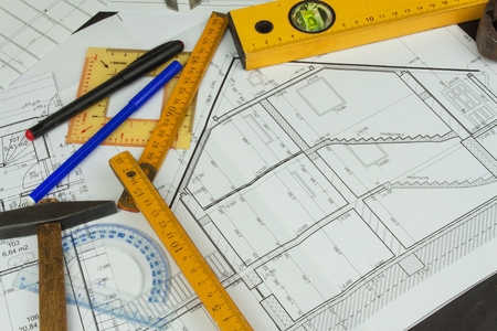 Desk project supervisor. Plans of building. Architectural project. Floor plan designed building on the drawing.の写真素材