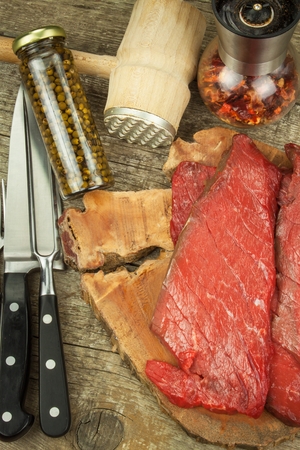 Preparing for grilling. Raw beef on a wooden board. Homework steakの写真素材