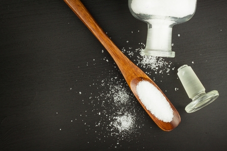 Fine sea salt on a wooden table. Spices on the table. Sales flavors