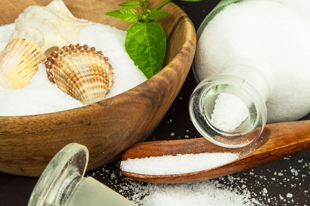 Fine sea salt on a wooden table. Spices on the table. Sales flavorsの写真素材