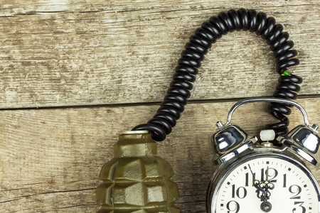 Grenade and old alarm clock. Timed bomb. The concept of terrorismの写真素材