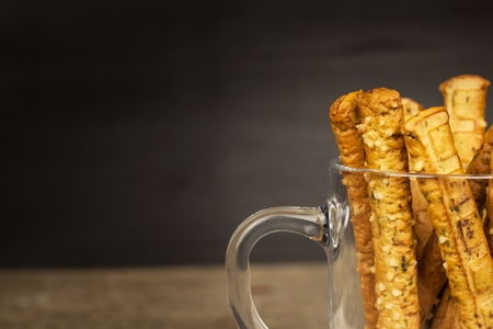 Salt sticks in a glass. Snack party. Unhealthy pastry for beer
