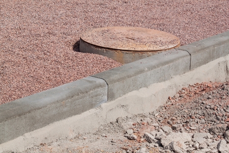 Concrete curb on new building site. Roadwork