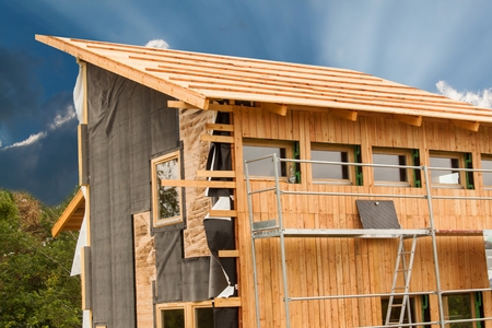 Ecological construction.  Lining the house of larch boards. Heat insulation. Construction worksの写真素材