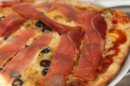 Domestic production of pizza. Preparing food for guests. Pizza party. Ham pizzaの写真素材