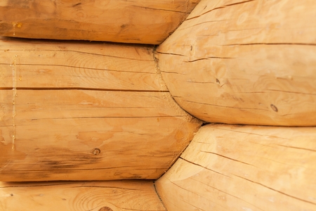 Modern Hand Hewn Natural Log Cabin Wall Facade Frame Texture.  Rustic Log Wall Square Timber Backgroundの写真素材