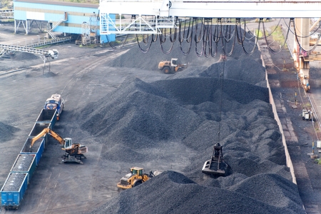 Work in port coal transshipment terminal.  Coal unloading of wagons with special cranes. Working in...
