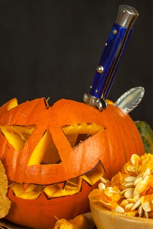 Making Jack a Lantern. Carving the pumpkin. Hollowing out and scary pumpkin to prepare a halloween lanternの写真素材