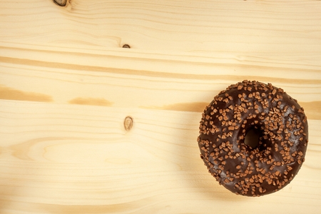 Donut on a wooden table. Unhealthy food. Dangers of obesityの写真素材