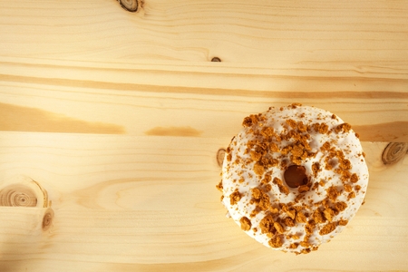 Donut on a wooden table. Unhealthy food. Dangers of obesityの写真素材