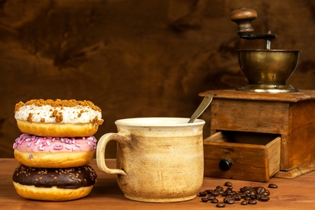 Donuts with coffee. Advertising for the sale of sweets. Sweet breakfast. Risk of obesityの写真素材