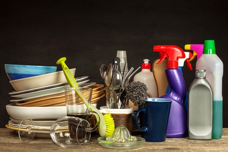 Washing kitchenware. Crockery on a wooden table. Cleaning after home celebration. Houseworkの写真素材