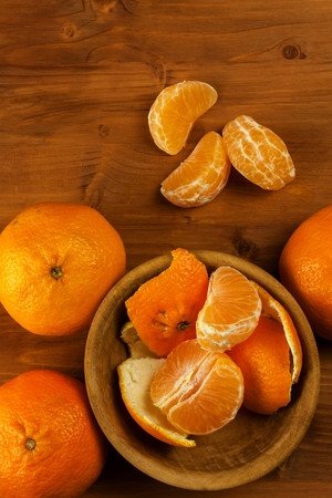 Fresh mandarins on a wooden table. Selling fruit. Vitamins against flu and cold. Advertising for tangerinesの写真素材