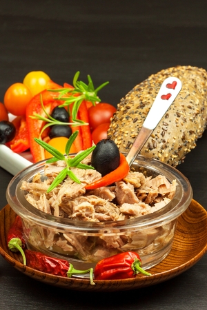 Pieces of tuna with vegetables. Preserved crushed tuna. Vegetables and fish. Healthy food for childrenの写真素材