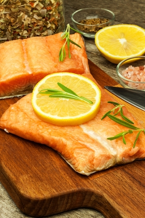 Frozen salmon on the kitchen table. Diet food. Home cooking fishの写真素材