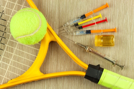 Tennis racket and ball. Anabolic steroids in tennis. Doping in sportsの写真素材