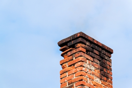 Old brick chimney. Chimney with sky in the background. Eco-friendly heating of a family houseの写真素材